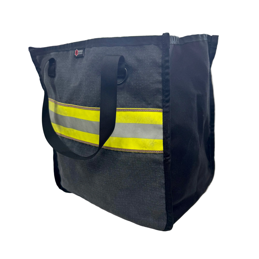 The Premier Tote bag crafted from authentic recycled fire bunker gear sitting on a neutral surface.