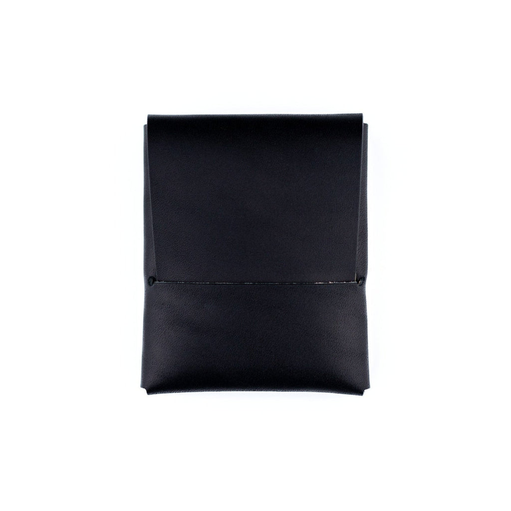 Black minimalist wallet made from a single piece of full-grain leather