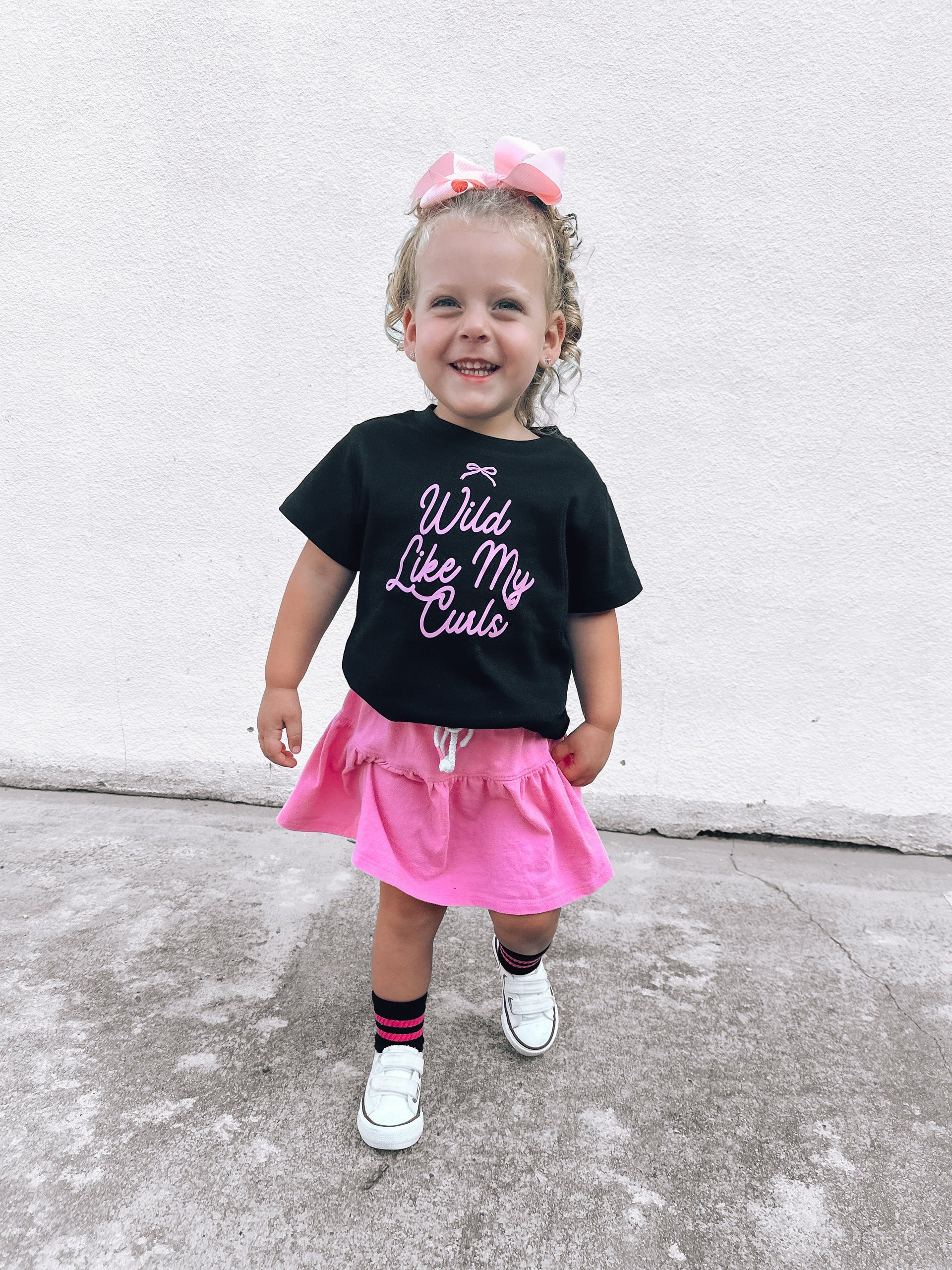 Wild Like My Curls Bow graphic tee available in black and pink for kids