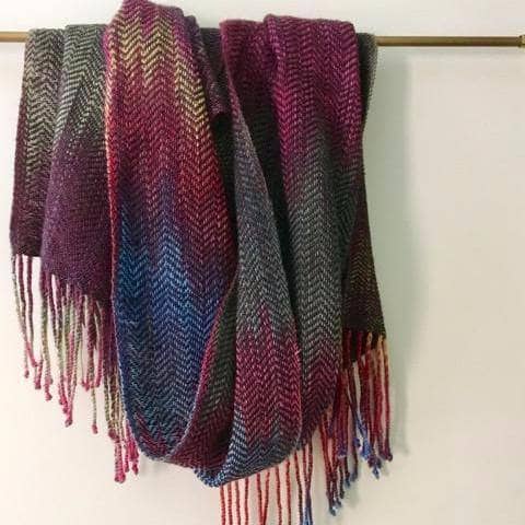 Cabito Wool Woven Scarf displaying intricate zig-zag pointe patterns and rich color variations.