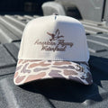 Brown trucker hat with OSC patterned brim and snapback closure
