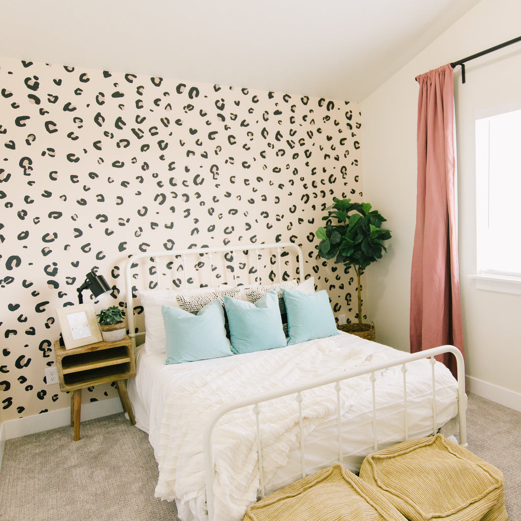 Nala wallpaper in beige and black with a modern bohemian animal print pattern
