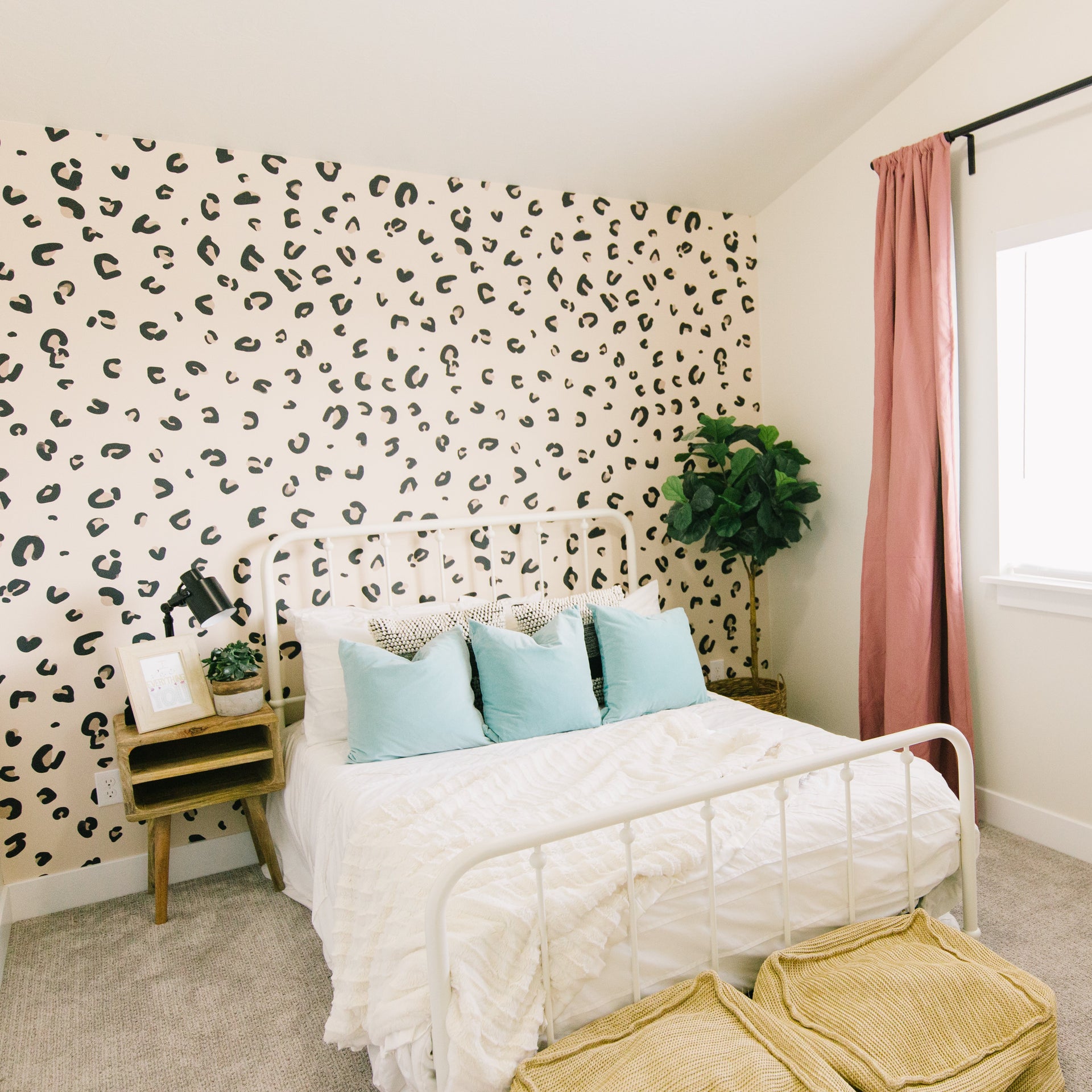 Nala wallpaper in beige and black with a modern bohemian animal print pattern