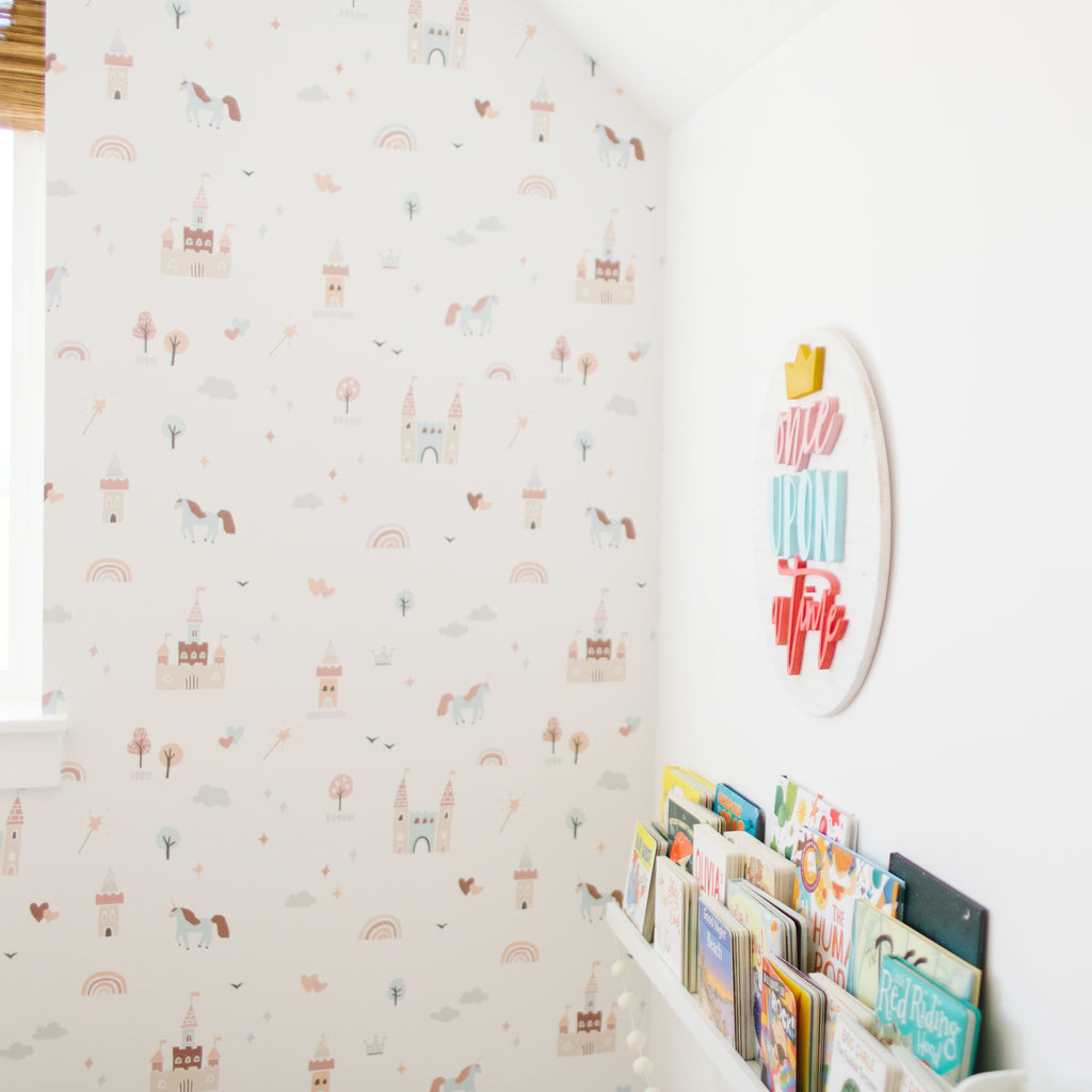 Ella whimsical nursery wallpaper in pastel pink, light blue, and soft orange.