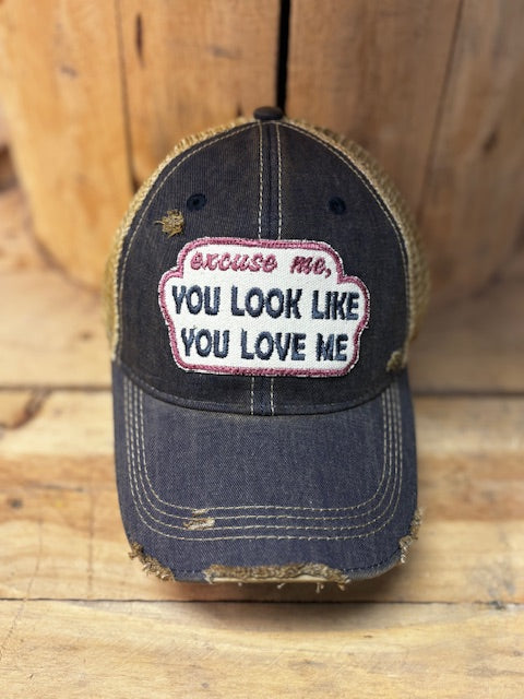 Distressed charcoal grey cap with tan mesh back and a patch that reads Excuse me, You Look Like You Love Me