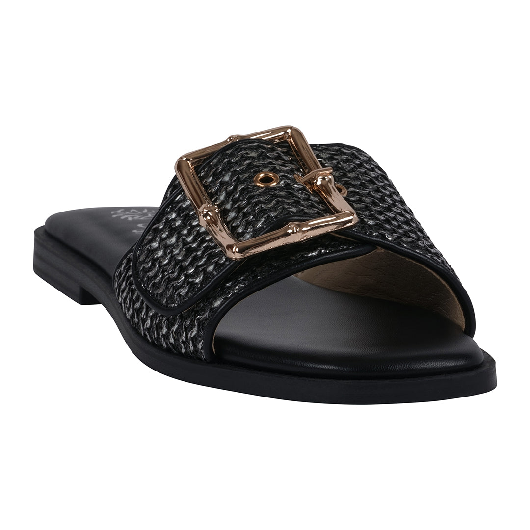 A pair of black women's flat sandals featuring a woven fabric strap and a large metallic decorative buckle.