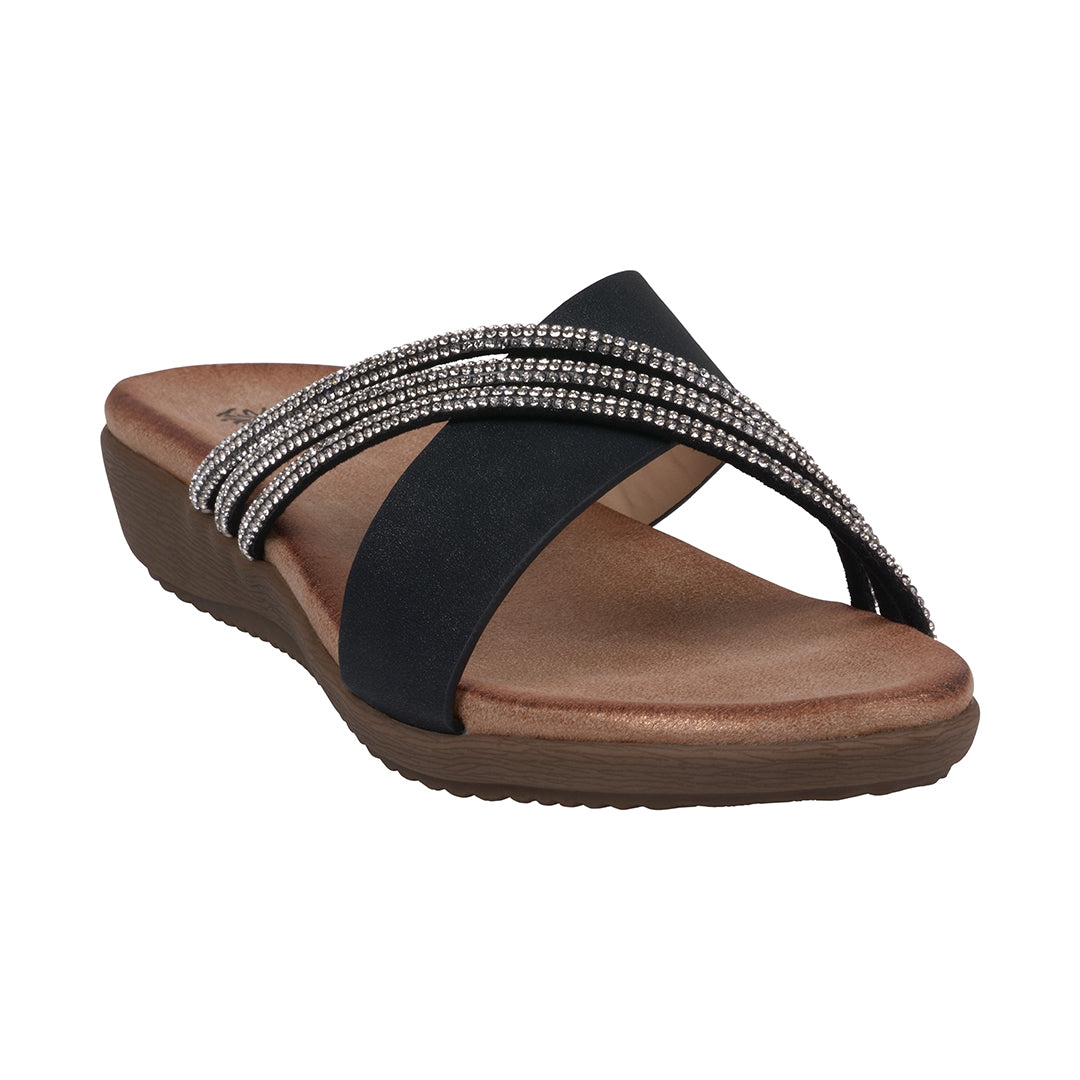 A pair of black asymmetrical flat sandals featuring sparkling embellished crisscross straps on a cushioned footbed.