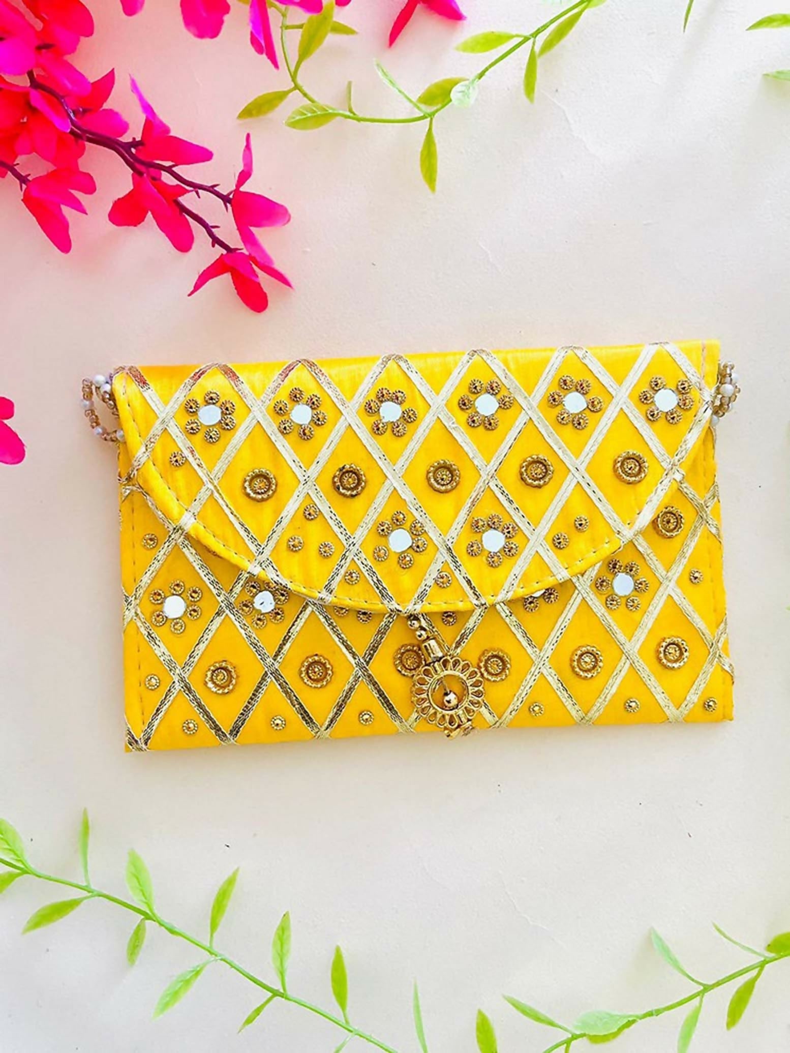 Bright yellow synthetic fabric clutch bag with a convenient magnetic lock closure.