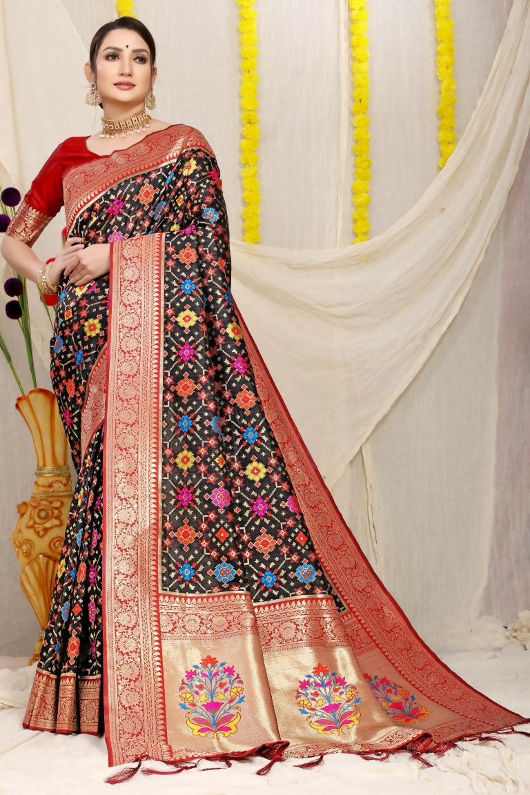 Black Patola silk saree featuring Zari woven work paired with a contrast maroon blouse