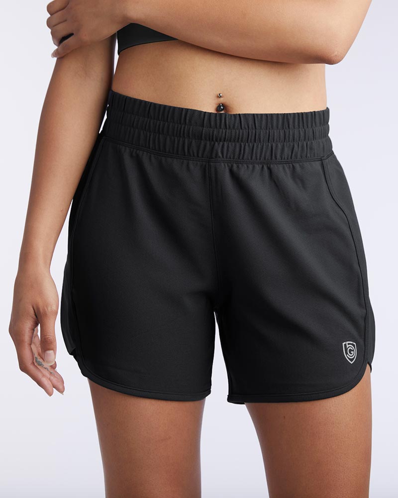 Back and front view of the black Indie women's athletic training shorts with an elastic waistband