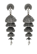 Silver color earrings with an intricate peacock design