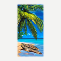 Colorful beach towel featuring a sea turtle on a sandy beach with palm trees against a blue sky.