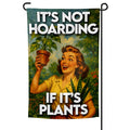 A 12x18 garden flag reading 'It's not hoarding! I'm just a Plantsperson' displayed in a garden.