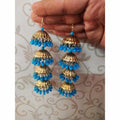 Four-tier umbrella design Jhumka earrings in gold tone with hanging blue pearls