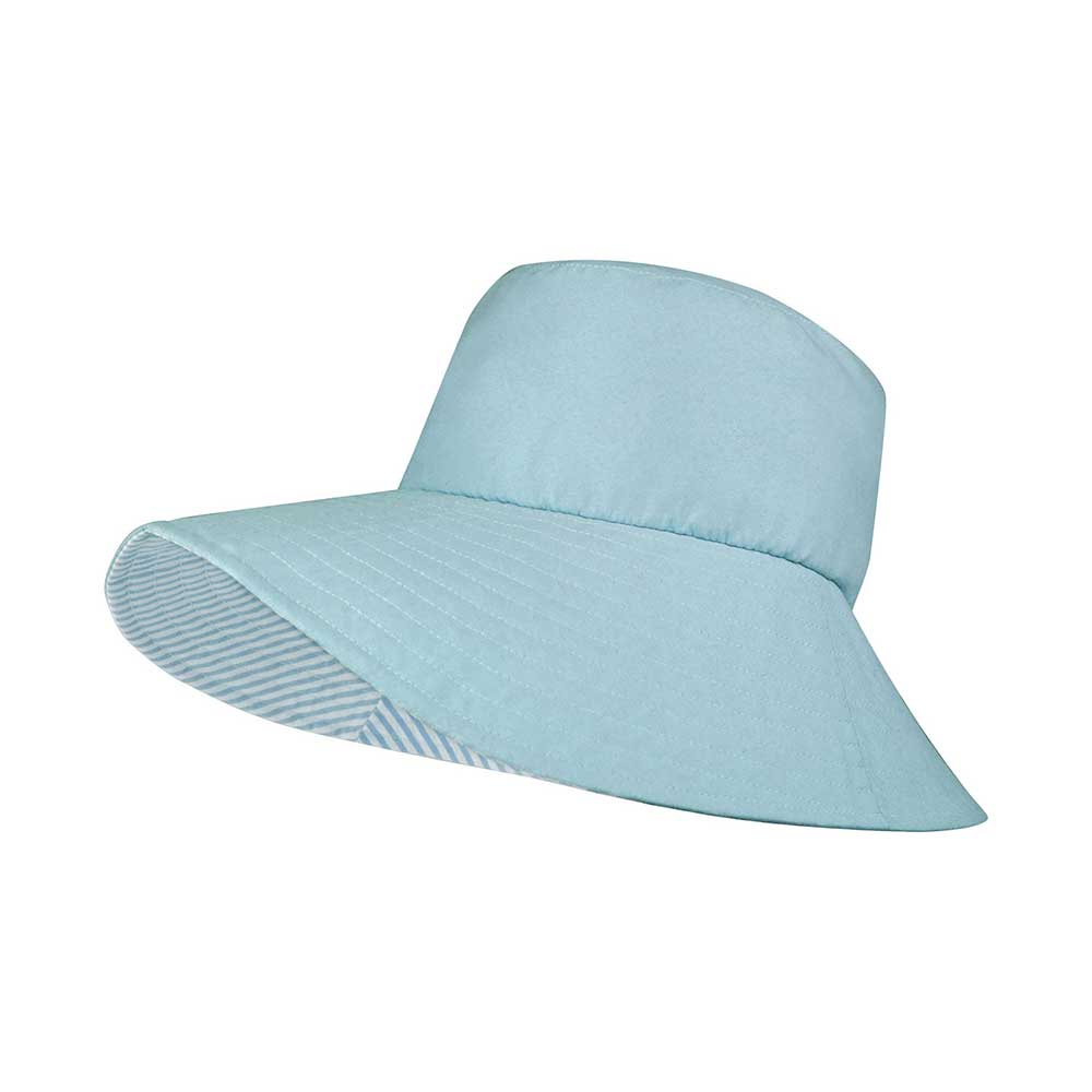 Womens wide-brim reversible bucket hat in blue and striped pattern worn outdoors