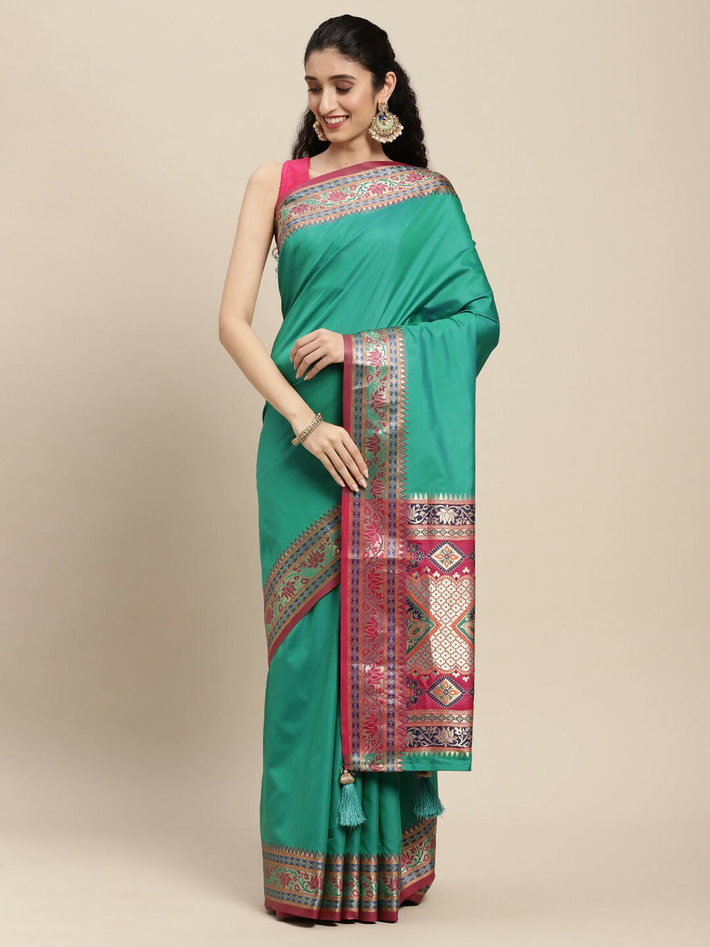 Women wearing a Rama green silk blend saree with geometric patterns and a matching blouse.