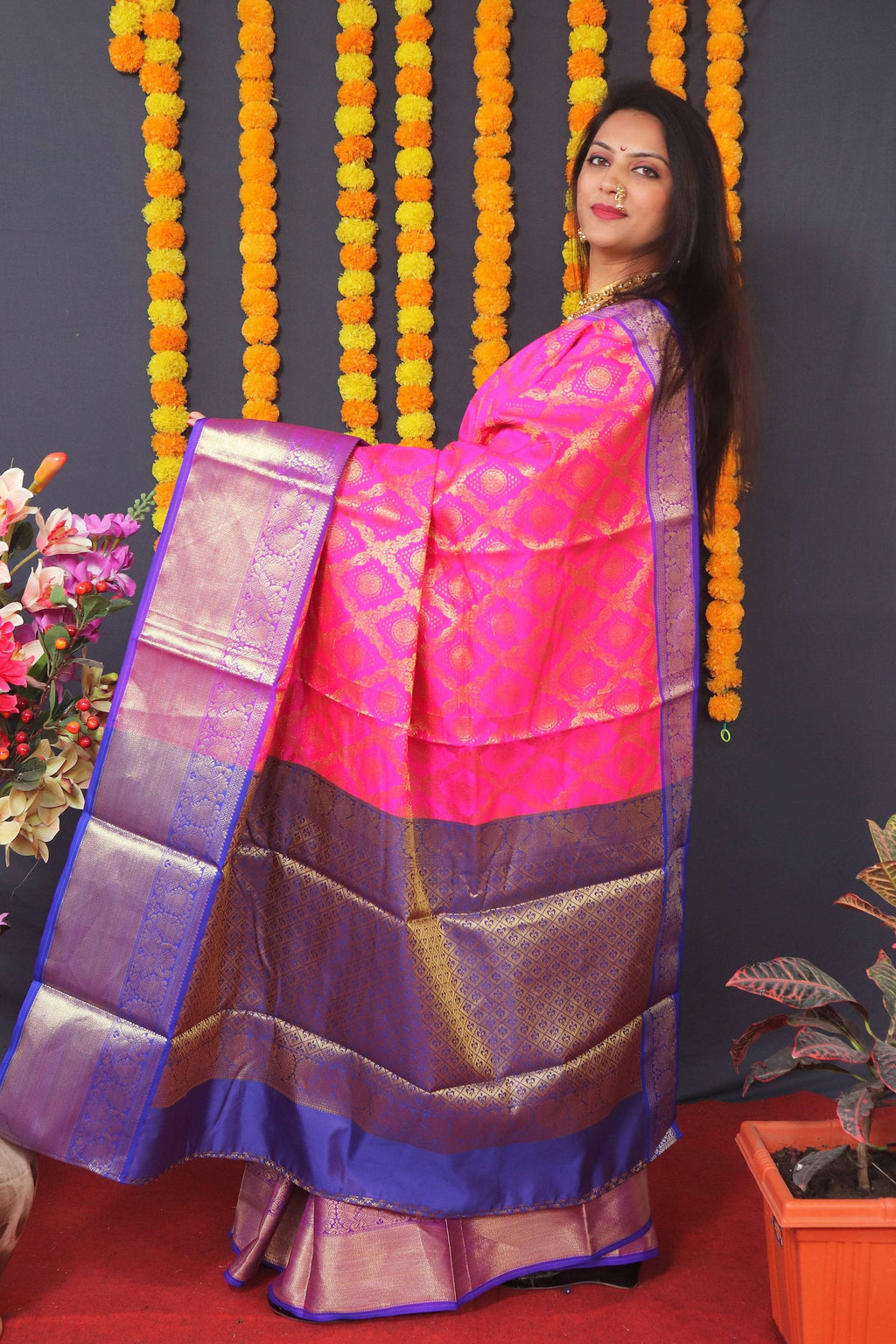 Pink Kanchipuram silk saree with intricate gold zari woven details