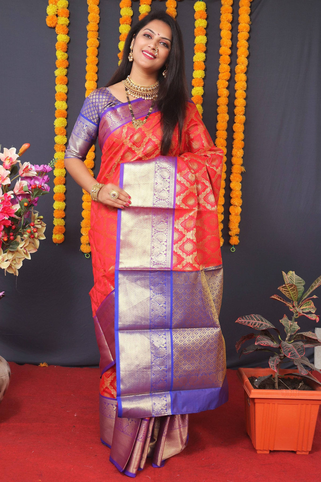 Red Kanchipuram silk saree with intricate Zari work and matching blouse