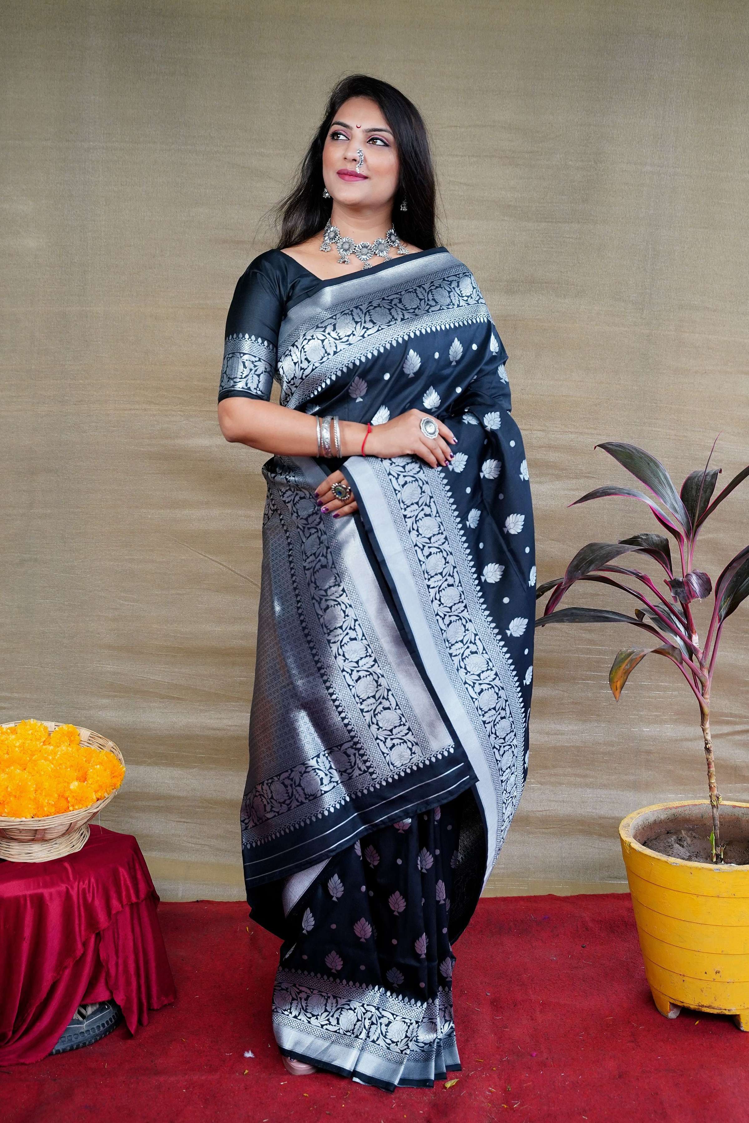 Elegant black soft Banarasi silk saree with intricate gold zari woven borders and matching blouse.