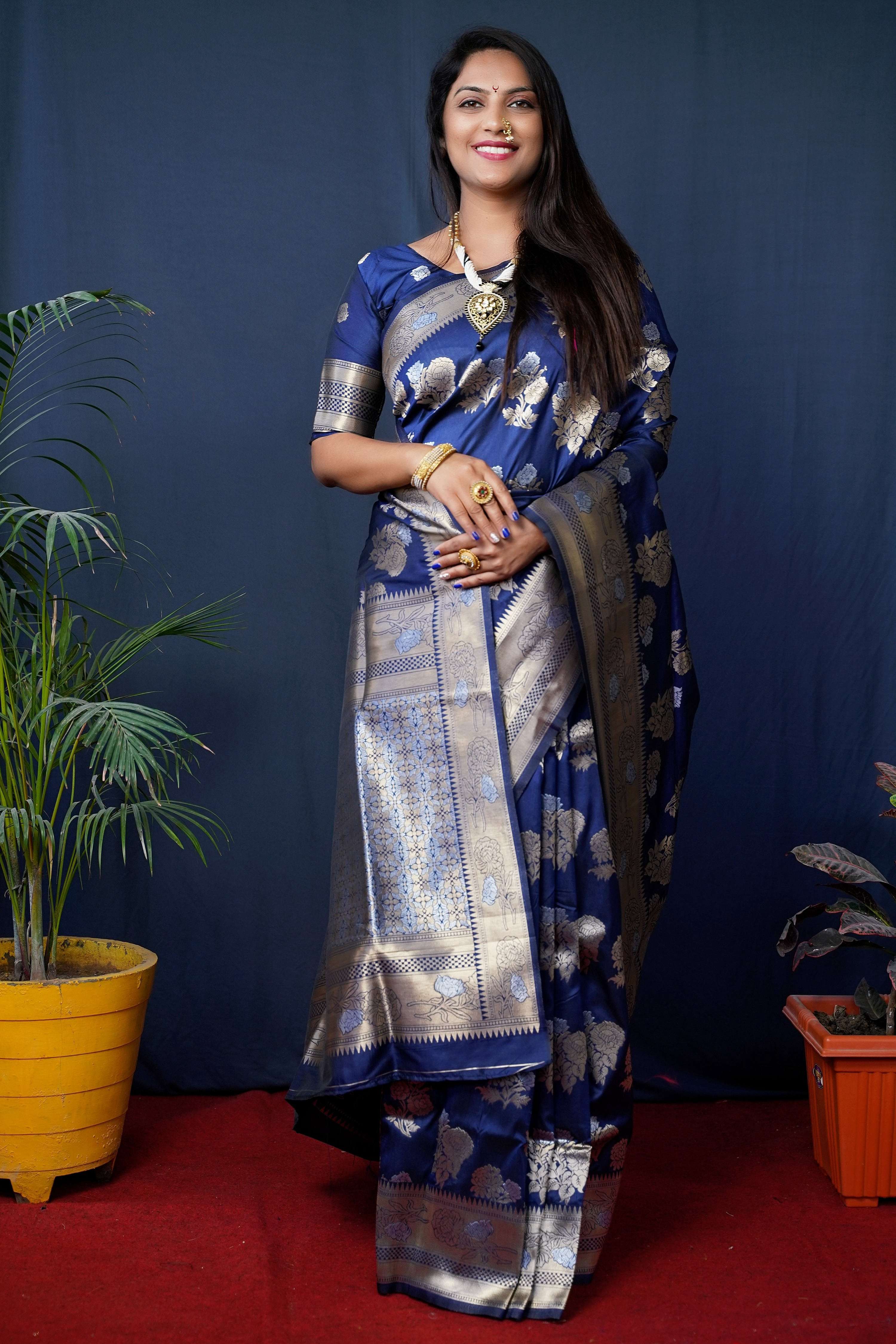 Navy blue Banarasi silk saree with gold zari woven patterns and matching blouse.