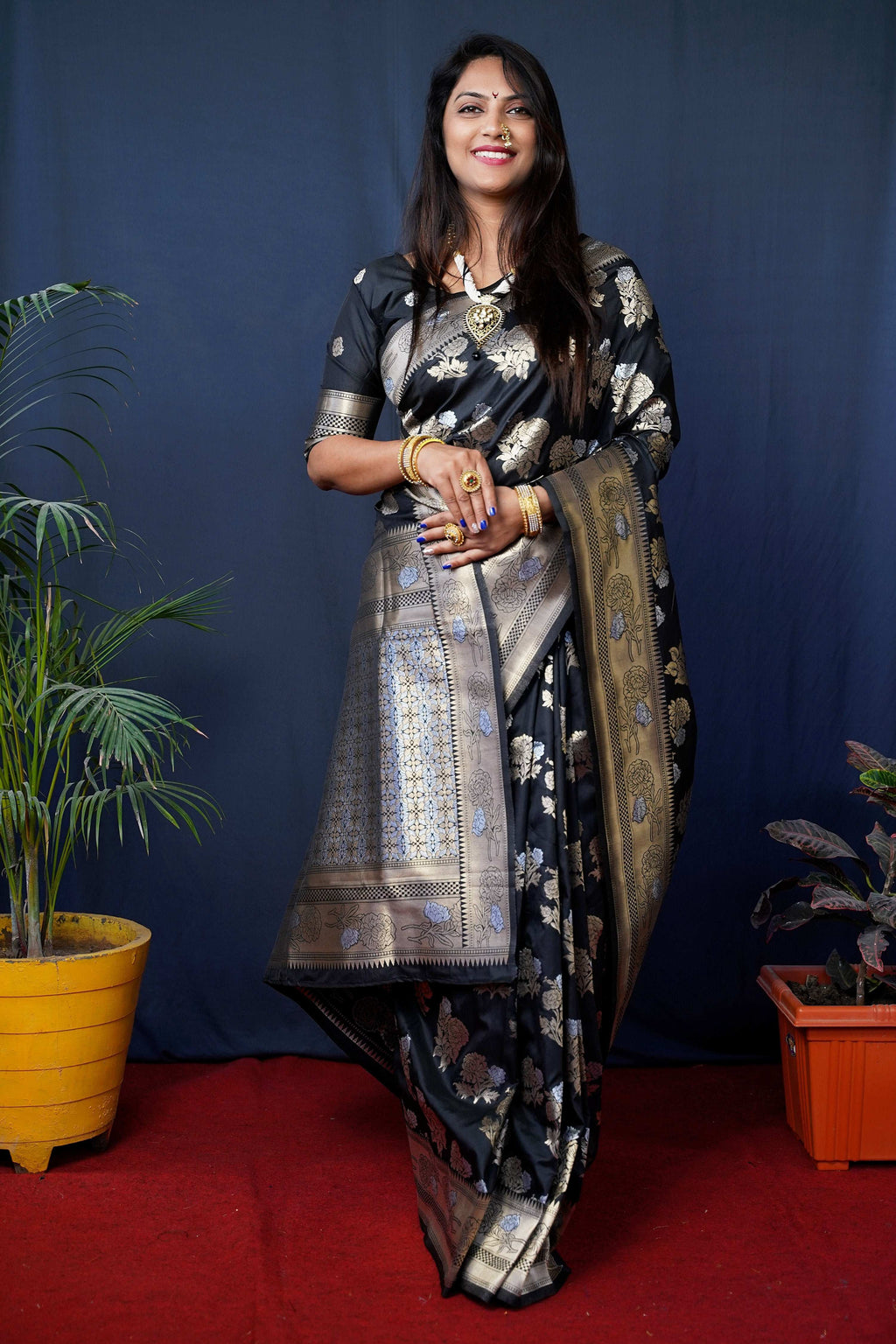 Black handloom Banarasi silk saree with intricate Zari woven detailing and matching blouse.