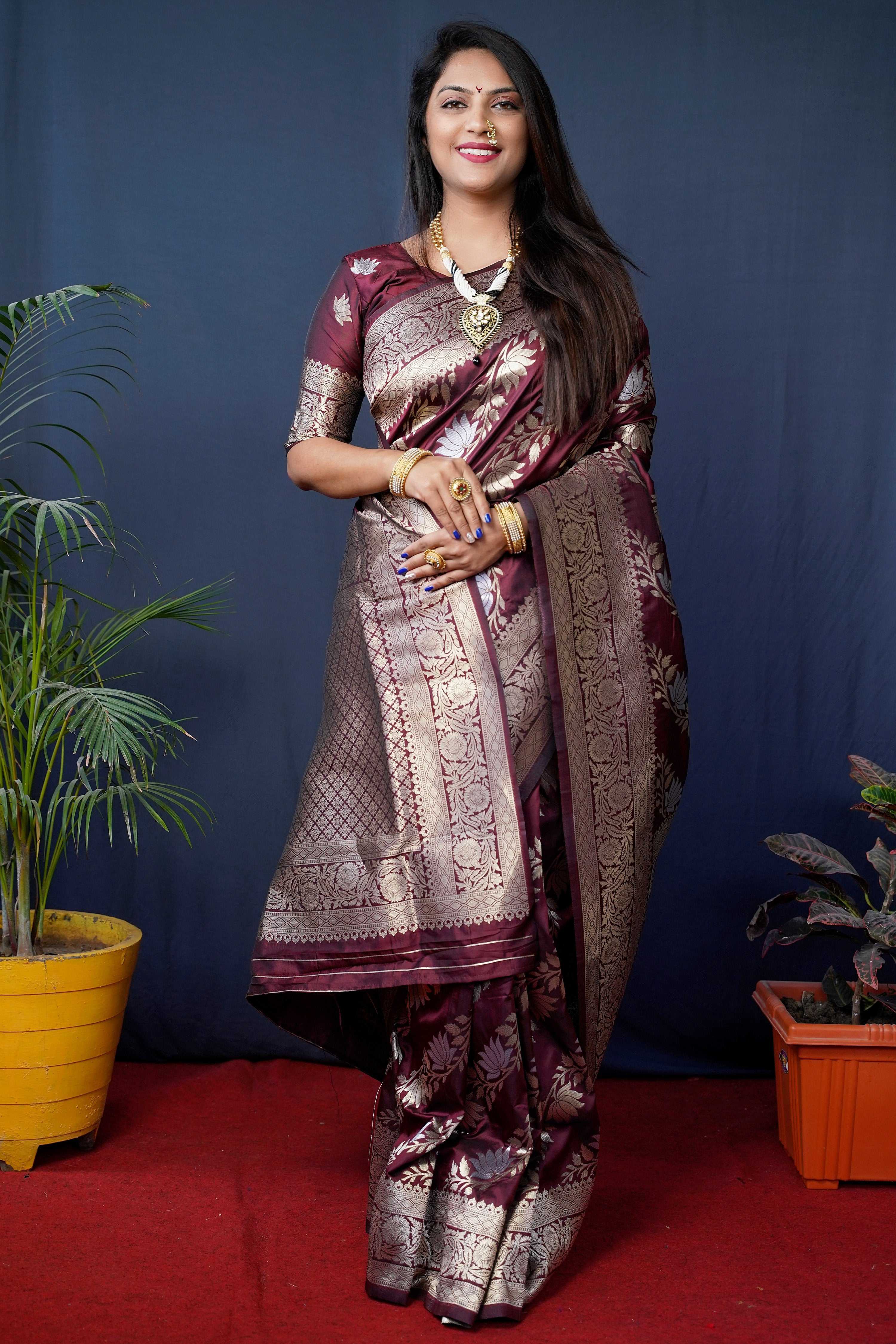 Rich maroon handloom Banarasi silk saree with intricate zari work.