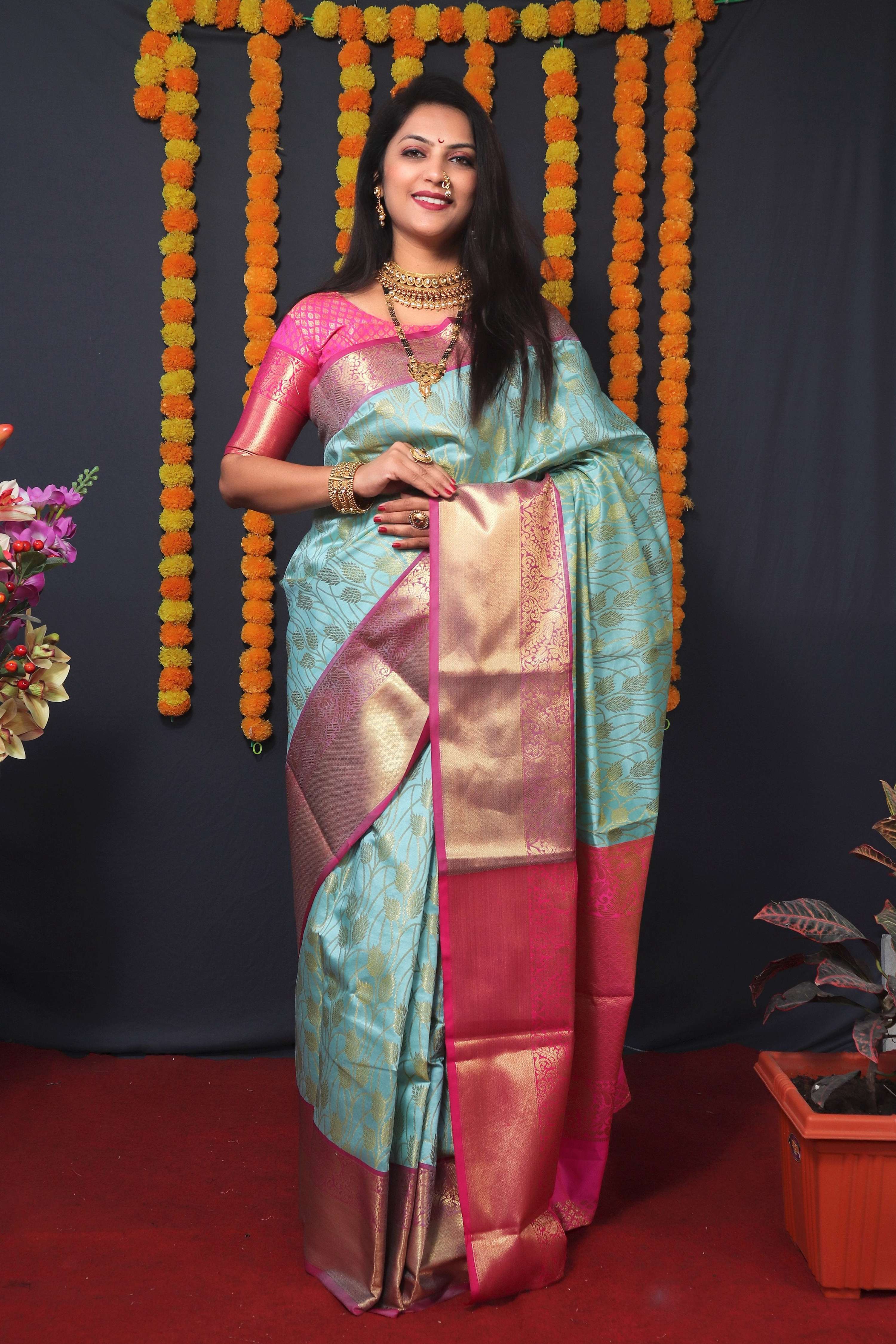 Sky blue Kanchipuram silk saree featuring ornate zari woven designs and matching half-sleeve blouse.