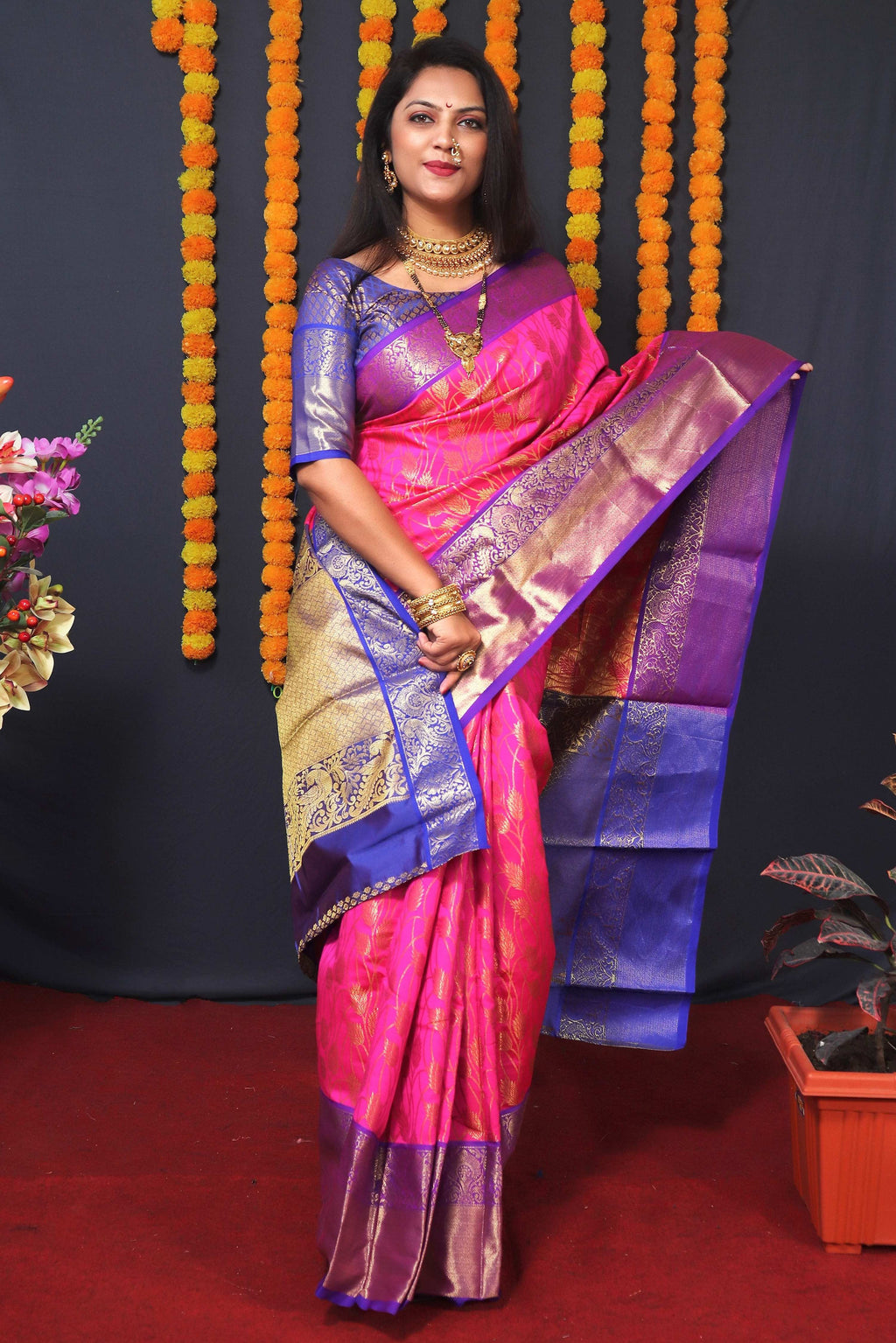 Elegant pink Kanchipuram silk saree with gold zari woven patterns and matching blouse