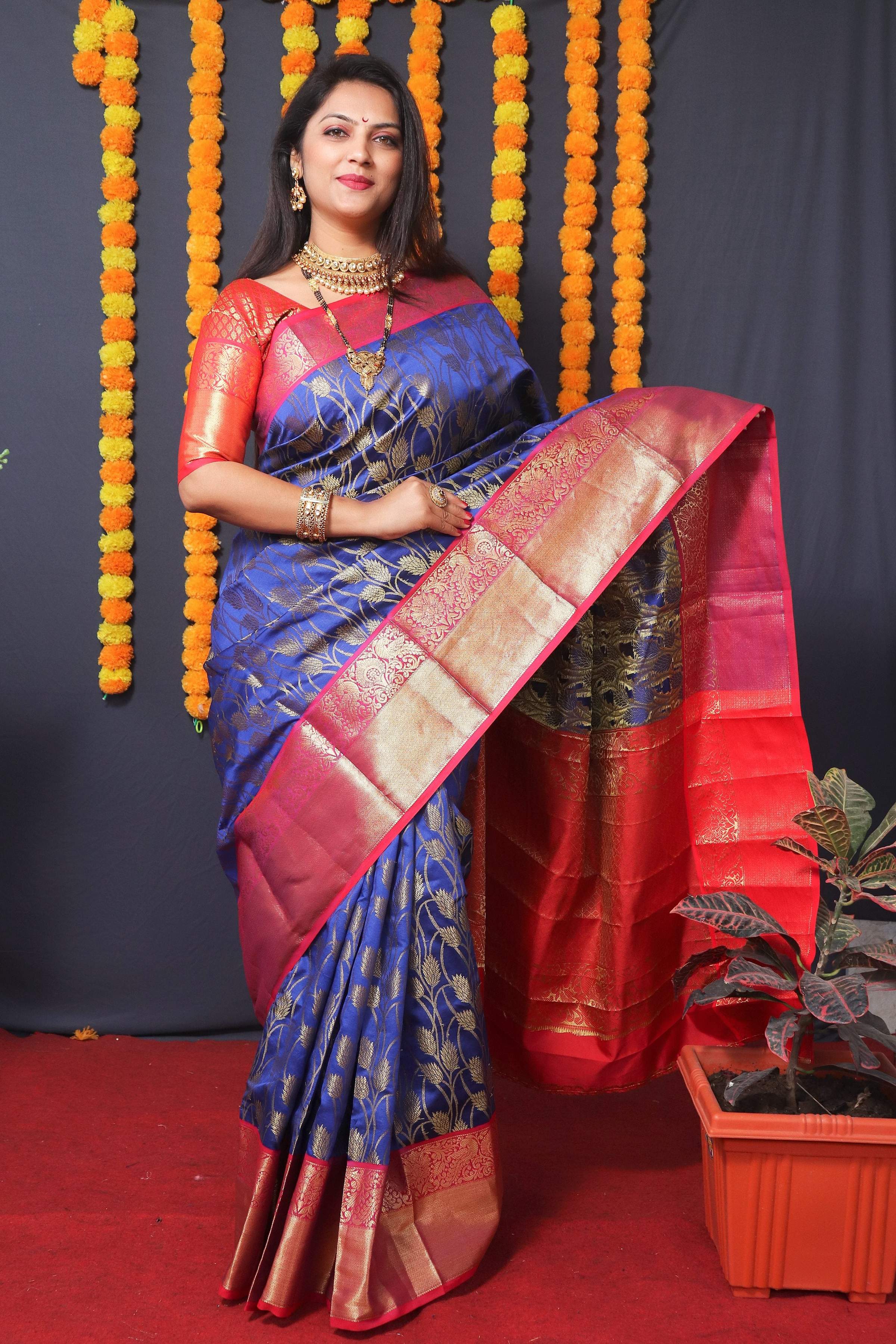 Blue Kanchipuram silk saree with intricate zari weaving.