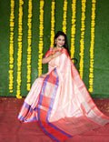 Peach colored Kanchipuram silk saree with intricate gold zari weaving.
