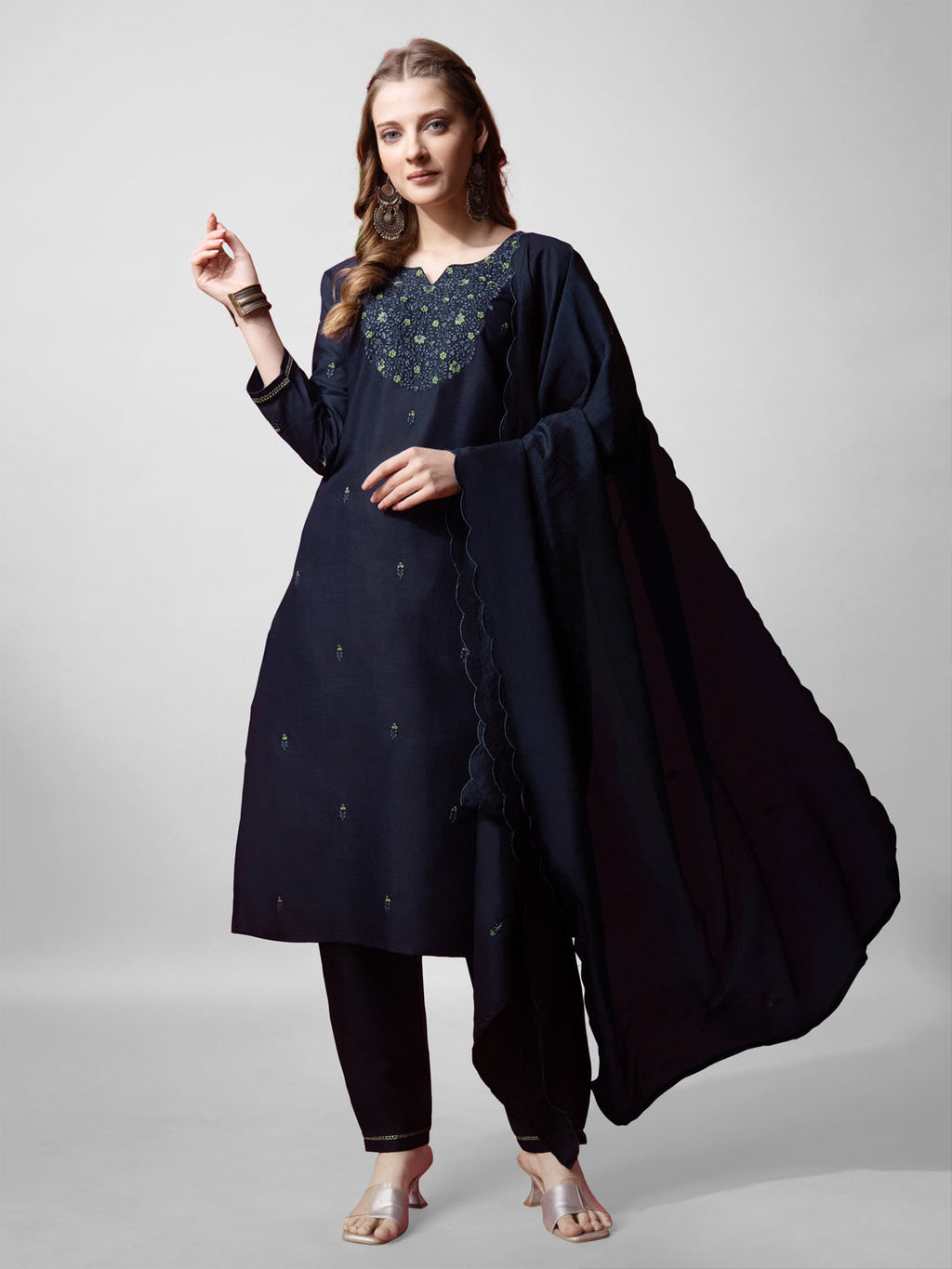 Woman wearing a navy blue cotton blend straight kurta with intricate embroidery.