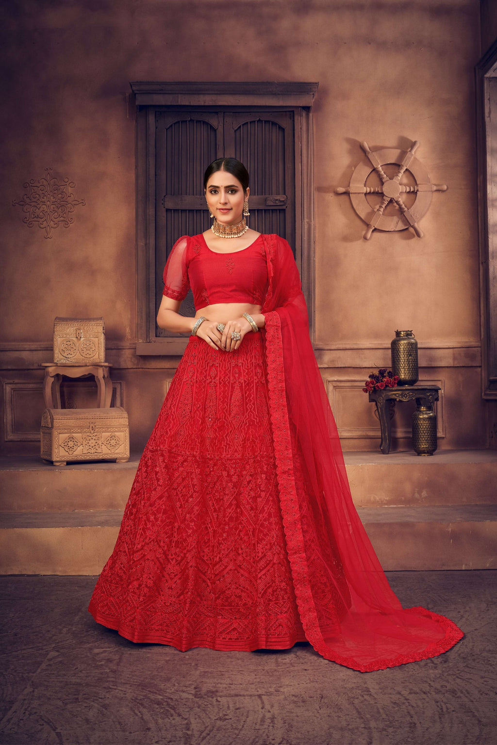 Red net lehenga choli set with intricate thread embroidery