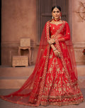 Women wearing a red taffeta silk lehenga choli with detailed thread embroidery.