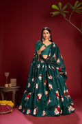 Women in a teal Banglory silk lehenga choli with floral print patterns.