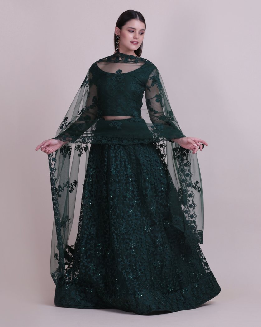 Dark green net lehenga choli with intricate thread embroidery detailing for festive occasions