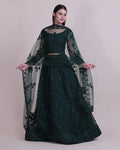 Dark green net lehenga choli with intricate thread embroidery detailing for festive occasions