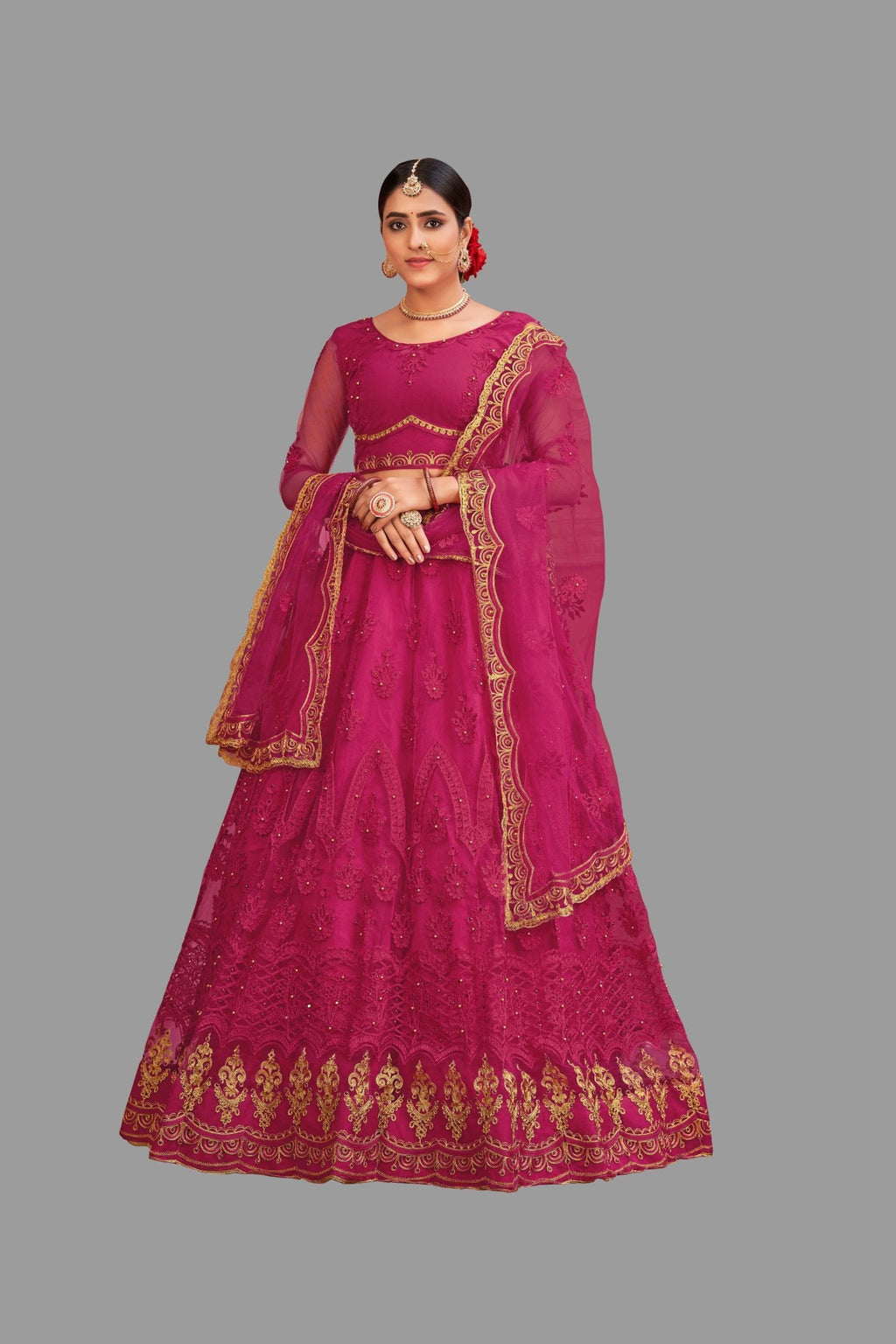 Women wearing a pink net lehenga choli with intricate thread embroidery