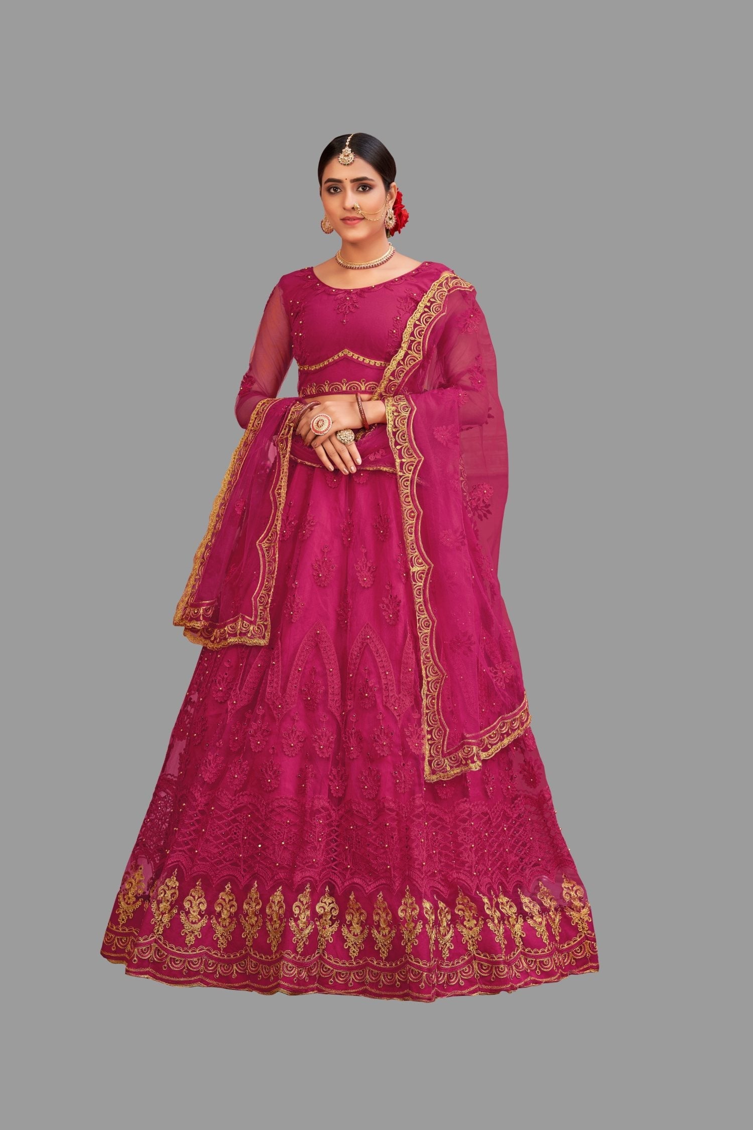 Women wearing a pink net lehenga choli with intricate thread embroidery