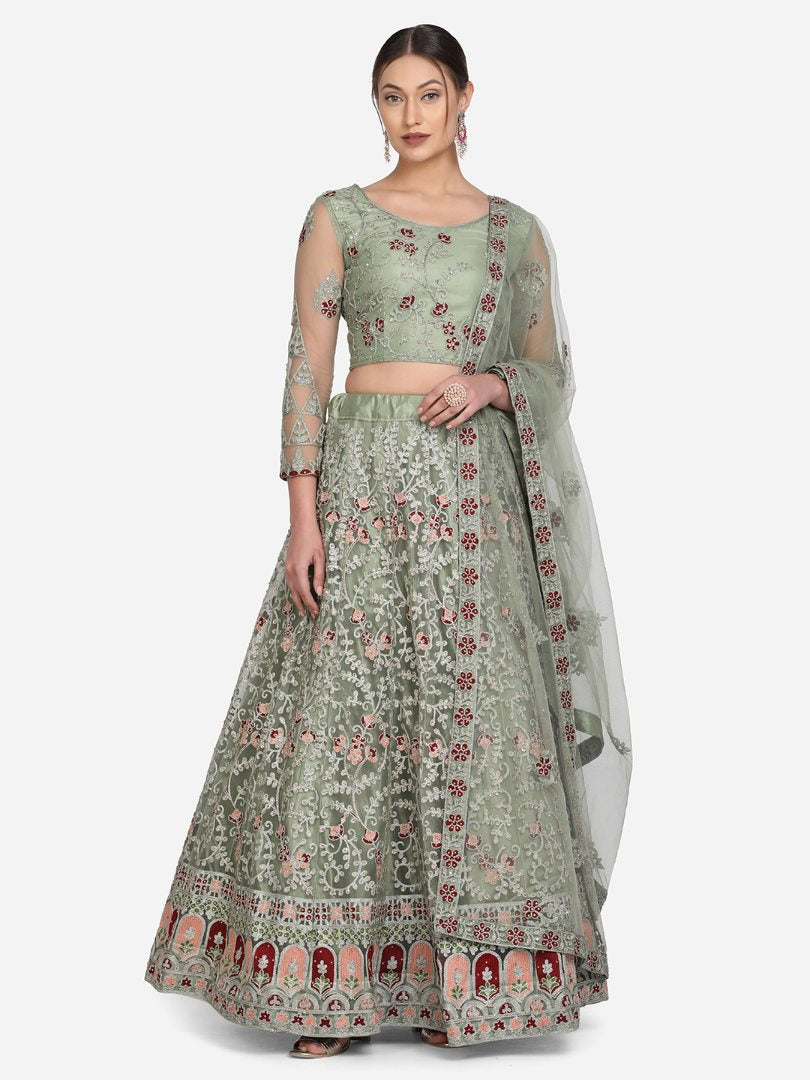 A beautiful light green designer lehenga choli with intricate thread embroidery on net fabric.