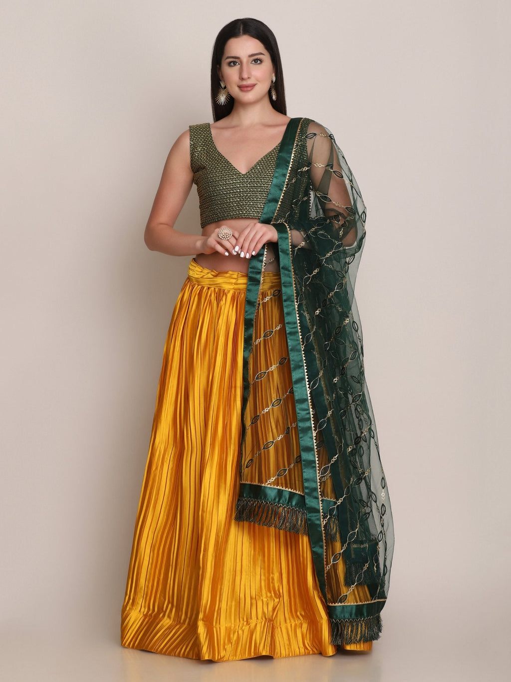 Woman wearing a yellow satin silk lehenga choli with platted work and dupatta
