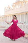 Woman wearing a Rani Pink Faux Blooming long Anarkali dress with sequins and zari work