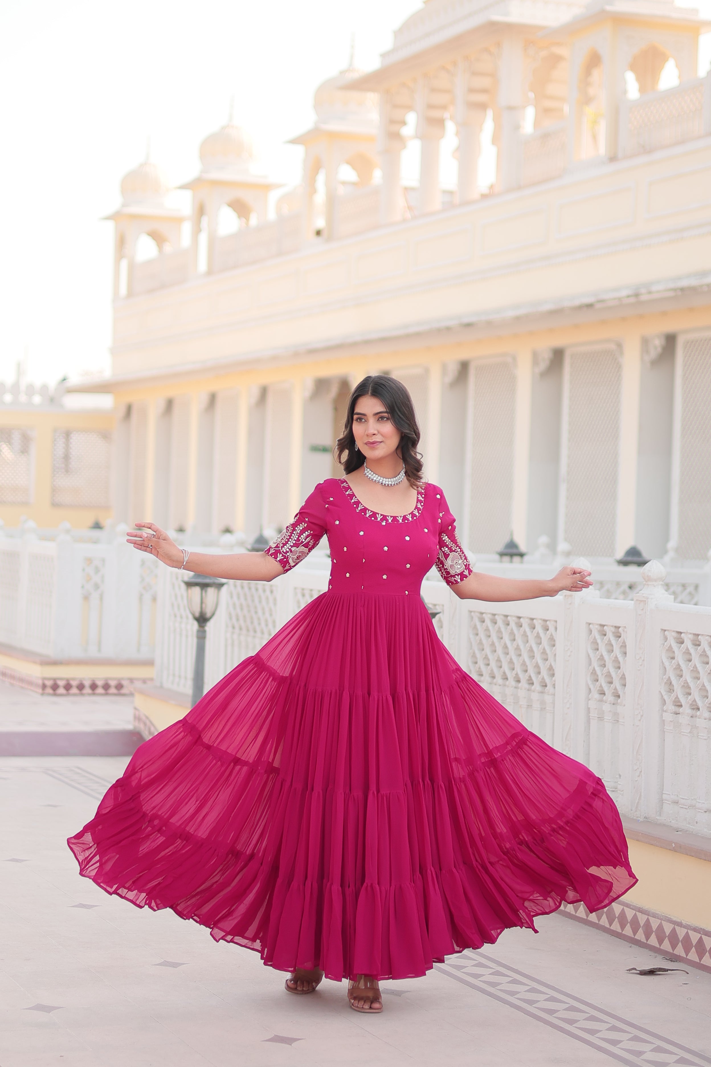 Woman wearing a Rani Pink Faux Blooming long Anarkali dress with sequins and zari work