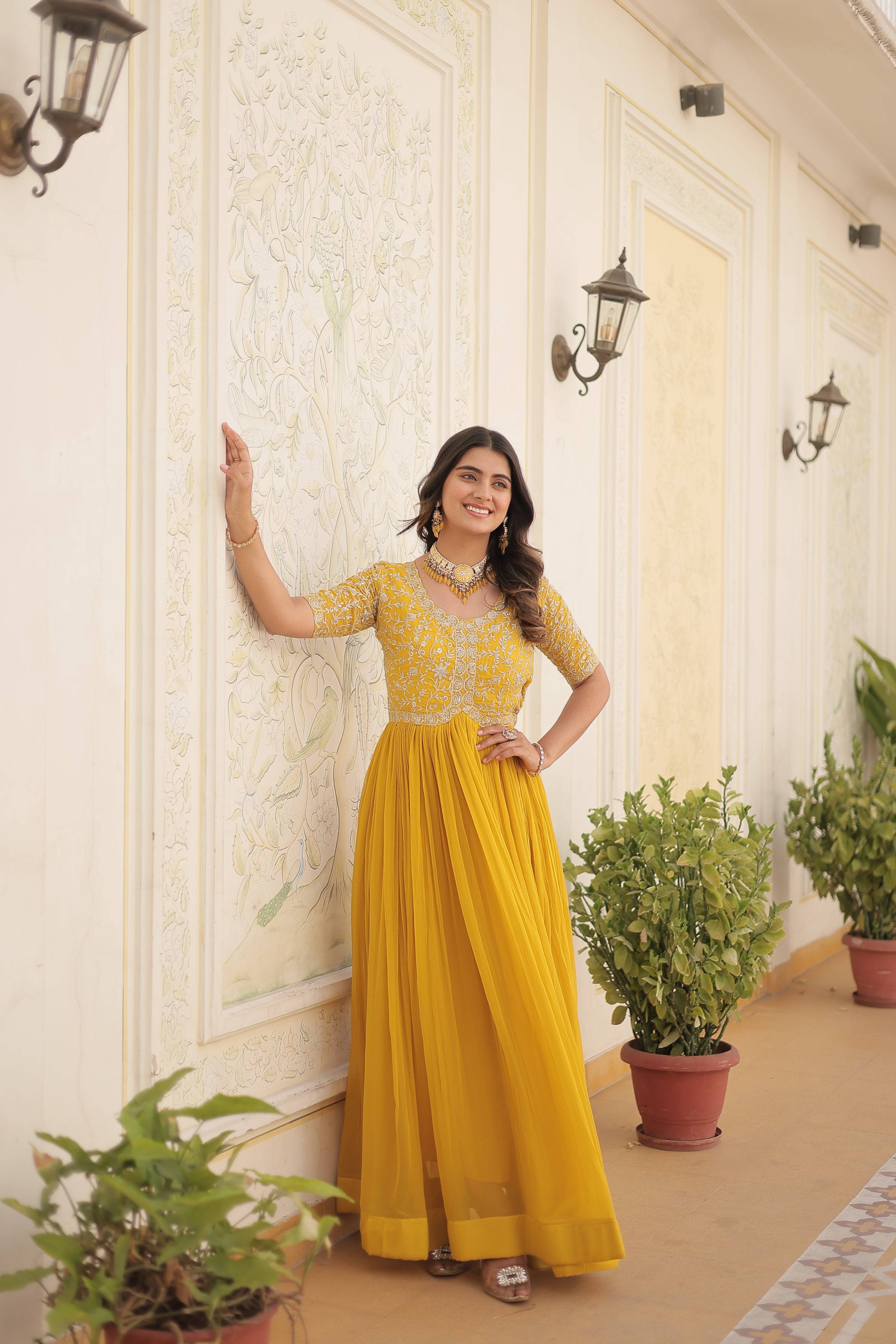Beautiful yellow Anarkali dress adorned with silver sequins and Zari embroidery.