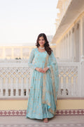 Woman wearing a sky blue faux georgette Anarkali kurta with intricate sequins and zari embroidery.