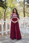 Elegant wine-colored floral Anarkali dress with gold sequins and embroidery.