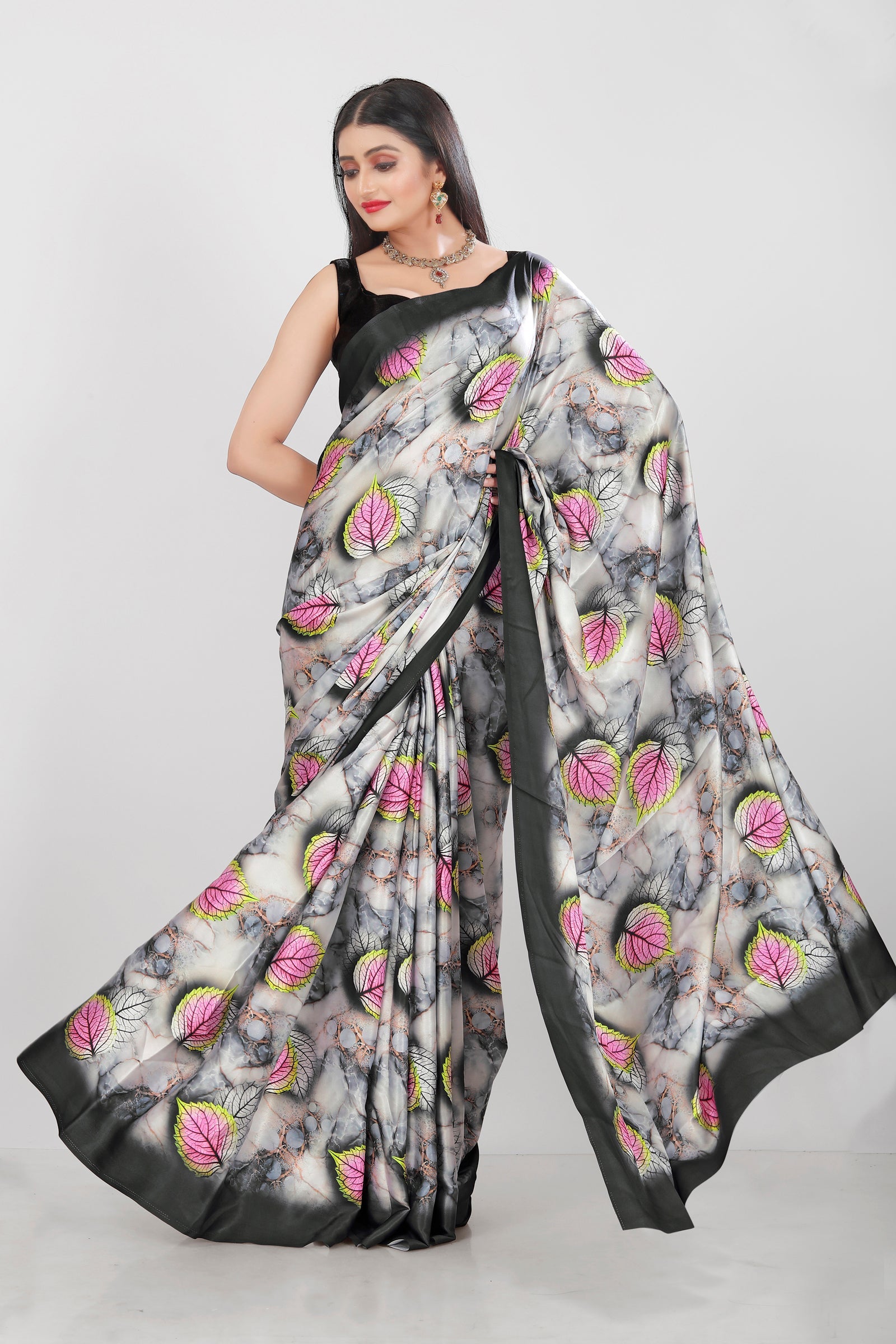 Elegant Japan Satin saree with floral digital prints in grey, black, pink, and white, styled for a glamorous occasion.