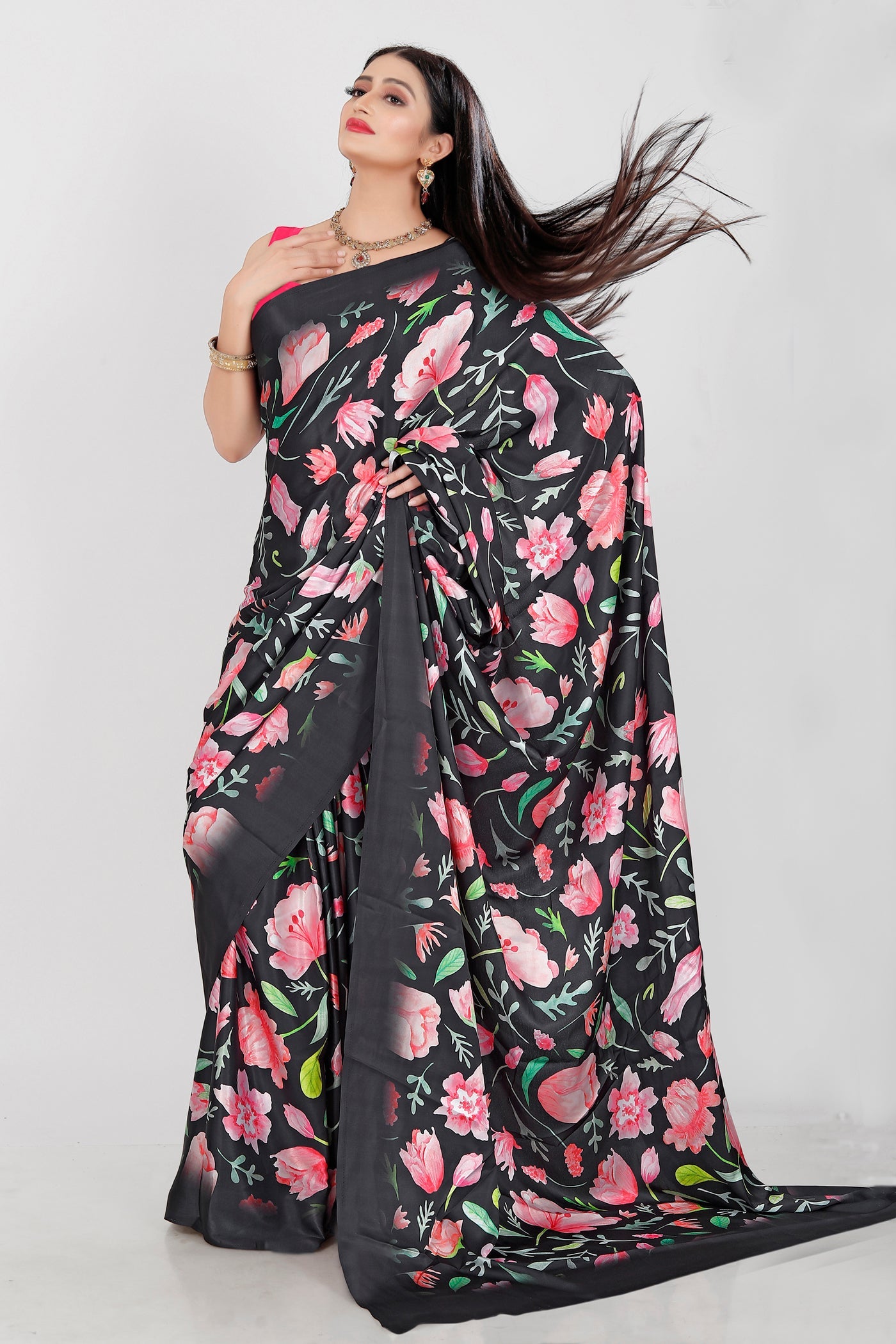 A beautiful Japan Satin saree featuring vibrant floral digital prints in black, pink, and green with a matching blouse.
