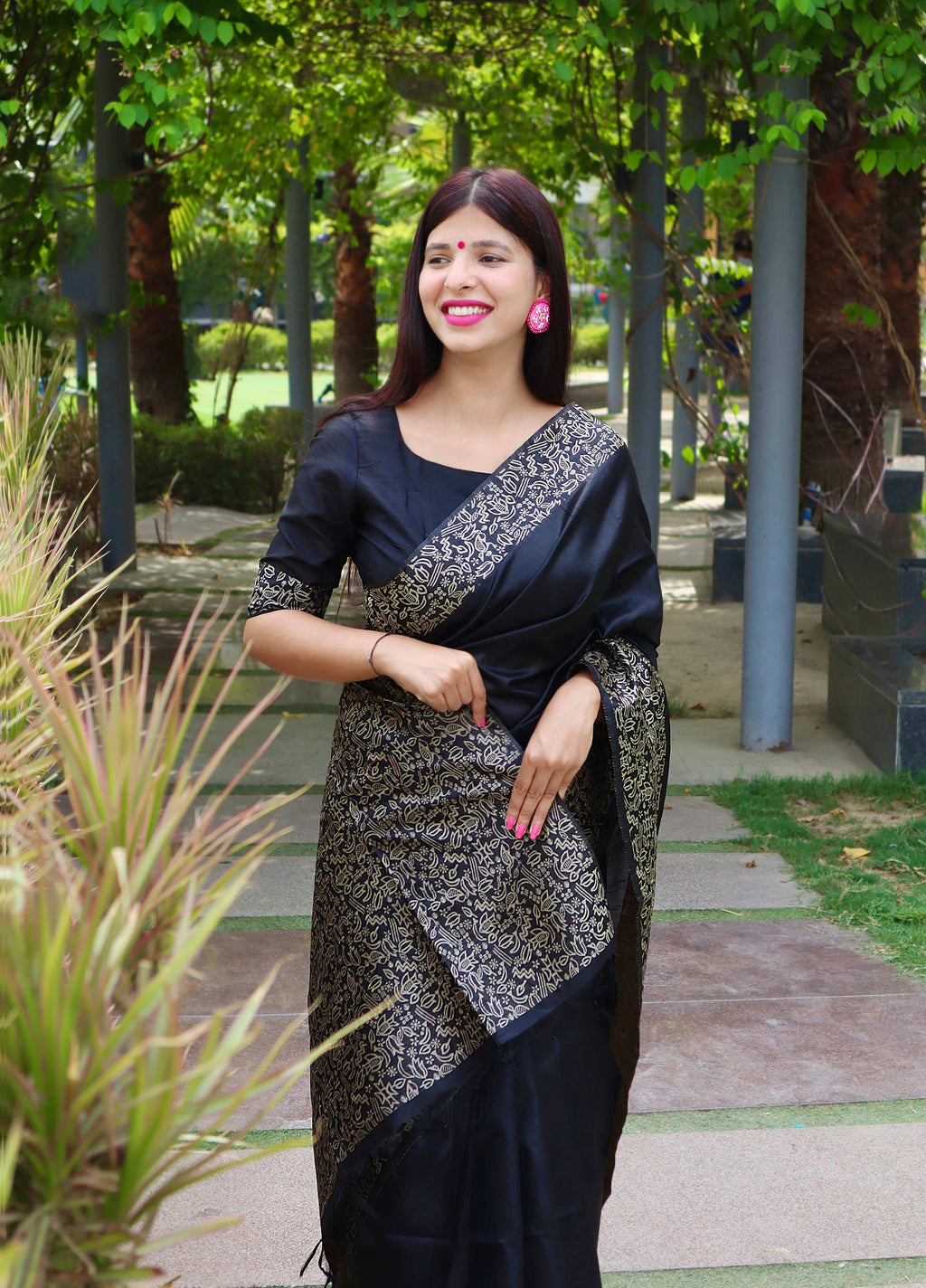 Black handloom raw silk saree with a printed border and matching blouse