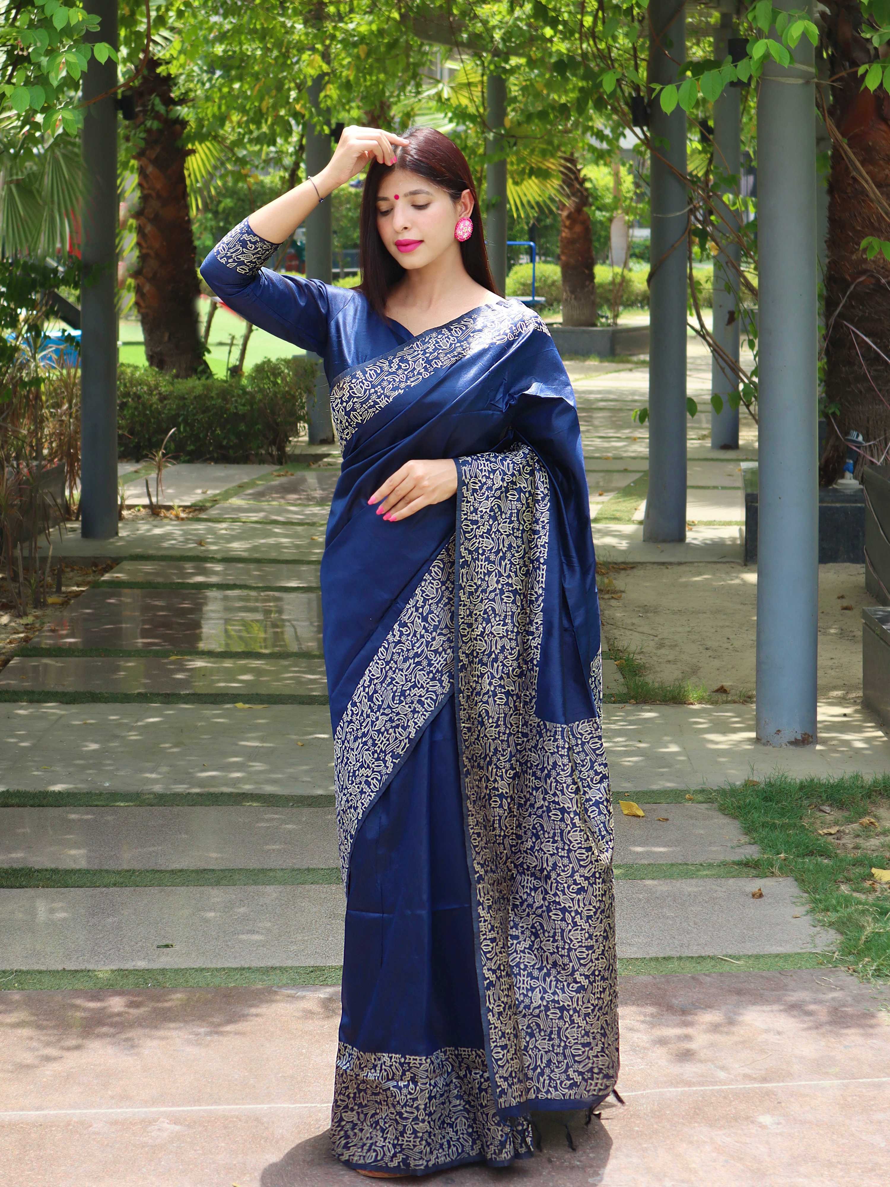 Blue handloom raw silk saree featuring a detailed printed border and matching blouse piece.