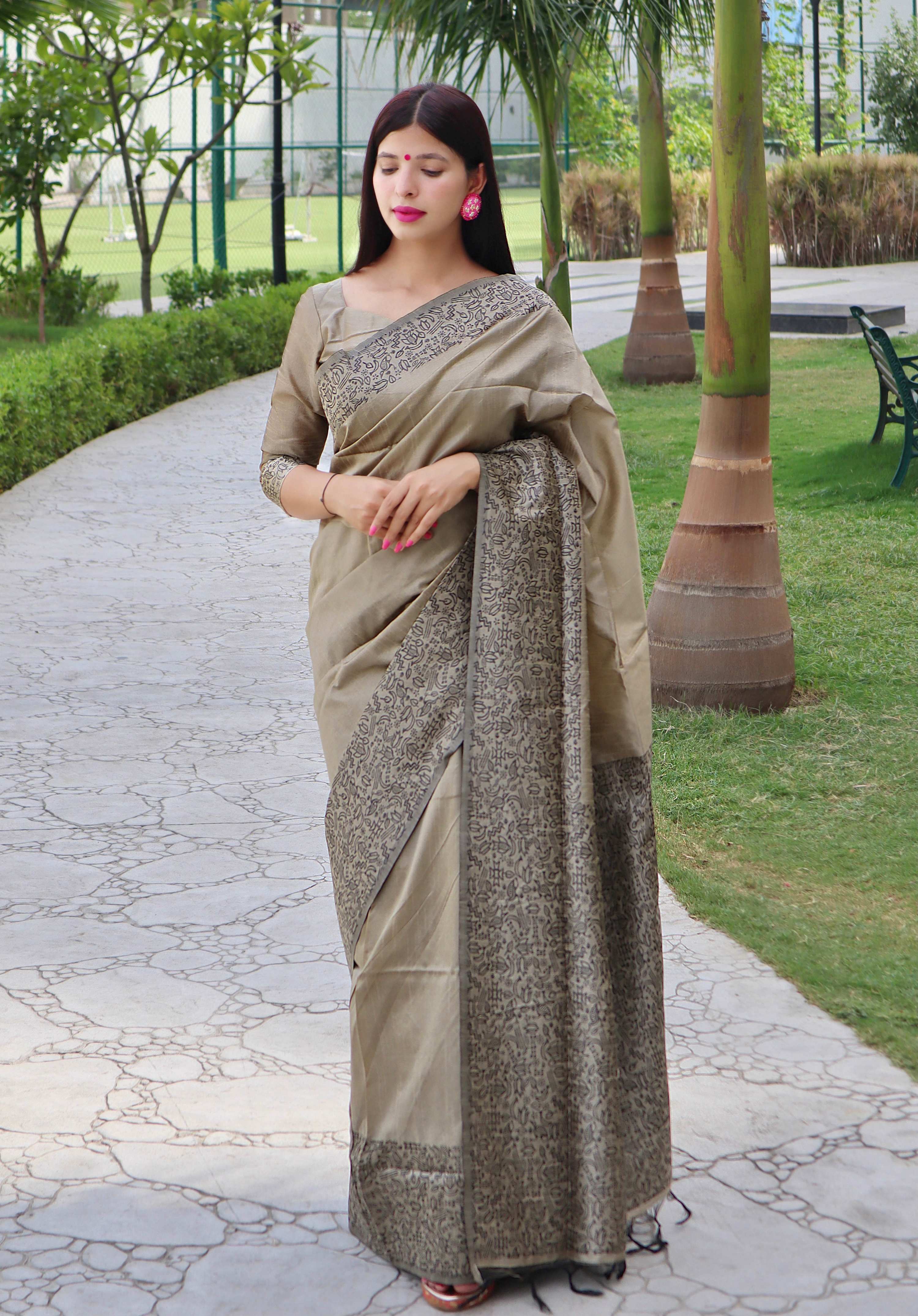 Cream handloom raw silk saree with a decorative printed border